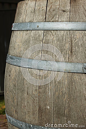 Germany. Heidelberg Castle. Fragment of an old wooden vine barrel with an metall hoop on a dark background. Wooden barrel with Stock Photo