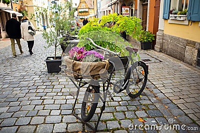 Germany, Rothenburg, fairy tale town, old streets, businesses, bicycles, flower baskets Editorial Stock Photo