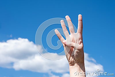 Gesture closeup of a woman`s hand showing four fingers, sign language symbol number four Stock Photo