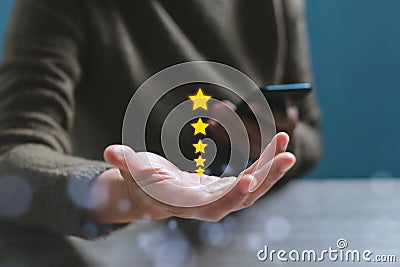 Gesture hand with golden five star awards. Opened hand of customer giving a five star rating. Stock Photo