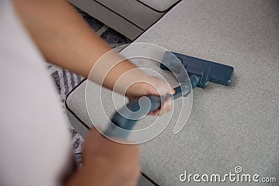 Hand using vacuum cleaner Stock Photo