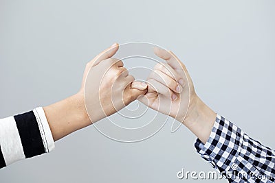 The gesture of the hands mean the promise on grey background Stock Photo