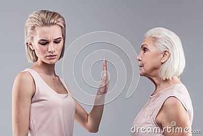 Categorical blonde woman shutting her mother up Stock Photo