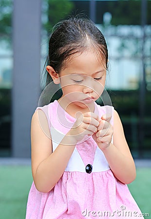 The gestures of children who lack confidence. Child girl intend her fingers Stock Photo