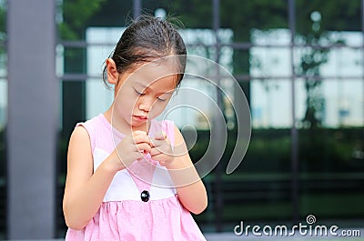 The gestures of children who lack confidence. Child girl intend her fingers Stock Photo