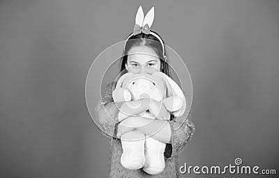 Get in easter spirit. Happy childhood. Bunny ears accessory. Lovely playful bunny child hugs soft toy. Have blessed Stock Photo