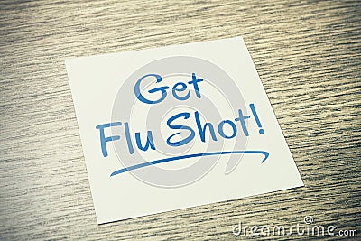 Get Flu Shot Reminder On Paper On Wooden Table Stock Photo