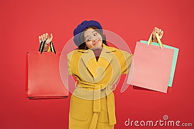 Get major wardrobe refresh with spring sales at stores. Obsessed with shopping. Girl cute kid hold shopping bags red Stock Photo