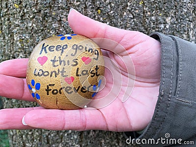 keep going painted stone landscape in hand Stock Photo