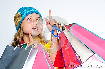 Get promo code. Shopping on black friday. Girl amazed face knitted hat hold shopping bags white background. Amazing Stock Photo