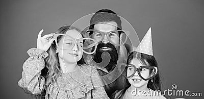 A get together. Family party. Happy family celebrating birthday party. Family of father and daughters wearing party Stock Photo