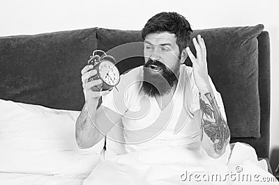 Get up with alarm clock. Overslept again. Tips for waking up early. Tips for becoming an early riser. Man bearded Stock Photo