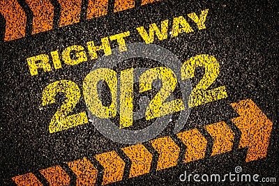 Motivational writing 2022 on asphalt as a metaphor for moving forward and happy new year concept Stock Photo