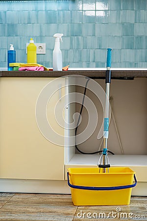 Get your house clean. Close up shot of floor cleaning bucket with mop and various cleaning detergents in the kitchen Stock Photo