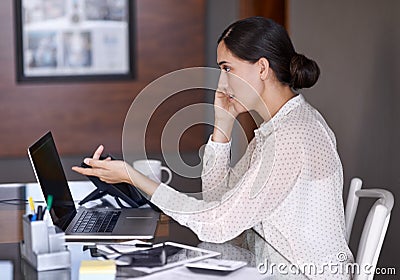 Getting everything done at once. a beautiful young woman working on her laptop. Stock Photo