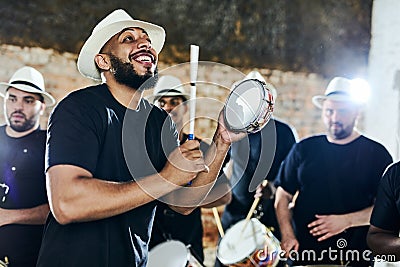 Getting into the groove of the music. a group of musical performers playing together indoors. Stock Photo