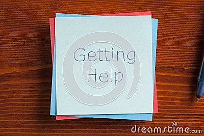 Getting Help written on a note Stock Photo