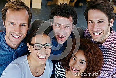 Getting the job done with a smile. Closeup portrait of a group of estatic coworkers standing in an office. Stock Photo