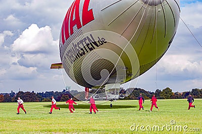 Airship, team preparing Zeppelin for landing Editorial Stock Photo