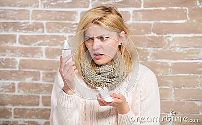 Getting rid of her stuffiness. Cute woman nursing nasal cold or allergy. Sick woman with nose drops. Suffering from Stock Photo