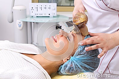 Getting snail skin cleaning at beauty salon. Stock Photo
