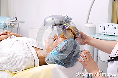 Getting snail skin cleaning at beauty salon. Stock Photo