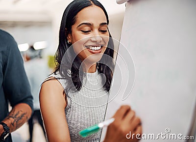 Getting some good input. an attractive young businesswoman using a visual aid to brainstorm with her colleagues in the Stock Photo