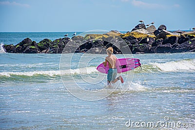 Getting In the Surf Editorial Stock Photo