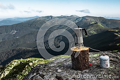 geyser kettle. making coffee in mountains with butane propane stove Stock Photo