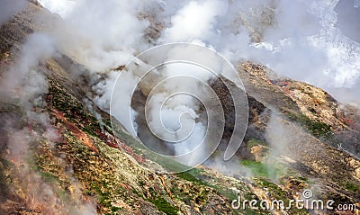 Geyser landscape with emissions of steam, gases and hot water in the country of volcanoes on the Kamchatka Peninsula Stock Photo