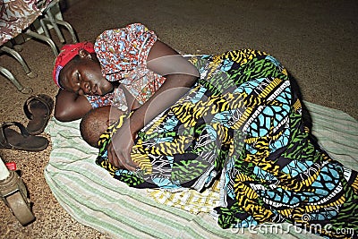 Ghanaian mother is sleeping with child on floor Editorial Stock Photo