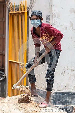 Indian migrant worker With Medical Mask At Construction Site During Unlockdown India Editorial Stock Photo