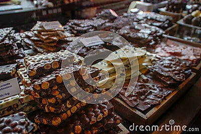 Different types of chocolate on a manazin showcase: milky, dark, with nuts, white Stock Photo