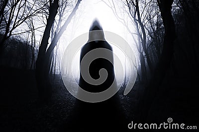 Ghost in dark haunted forest on Halloween Stock Photo