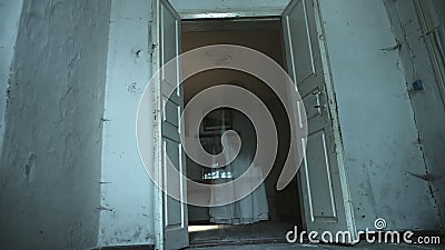 A ghost girl walks through an abandoned house Stock Photo