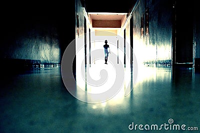 Creepy long hallway with the Ghost of a child. Dead little spirit in the hallway. Stock Photo