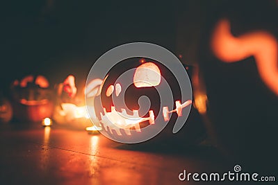 Ghost pumpkins on Halloween. ead Jack on Dark background. Holiday indoor decorations. Stock Photo