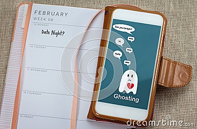 Ghosting on mobile phone on table with diary, Ghosted to cut all communication without explanation Stock Photo