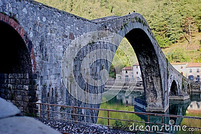 Giant Arches and pillars of the medieval Ponte della Maddalena bridge Editorial Stock Photo