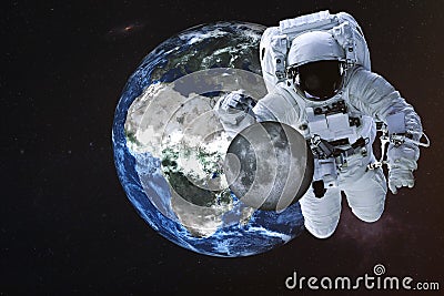 Giant astronaut near Earth planet with Moon Stock Photo