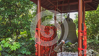 Giant bronze bell and red Chinese prayer charms, Hangzhou, China Stock Photo