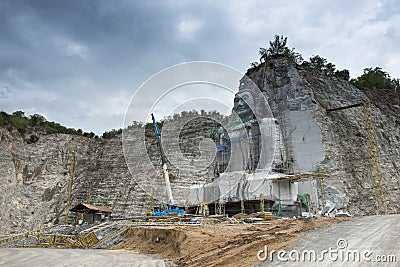 Giant Buddha was carved out of a cliff Editorial Stock Photo