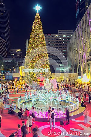 Giant Christmas tree and Christmas theme decoration and blurred people moving at Central World on night scene Editorial Stock Photo