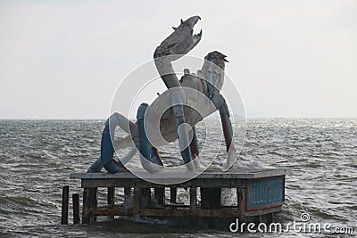 Giant crab statue on top of the wooden dock in the sea Editorial Stock Photo