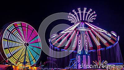 Giant Ferris Wheel and Yo-Yo Amusement ride Stock Photo