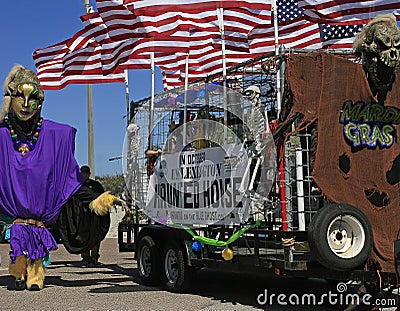 Giant, Flags and Haunted House in the Barefoot Mardi Gras Parade Editorial Stock Photo