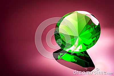 Giant green emerald on a red/ pink background Stock Photo