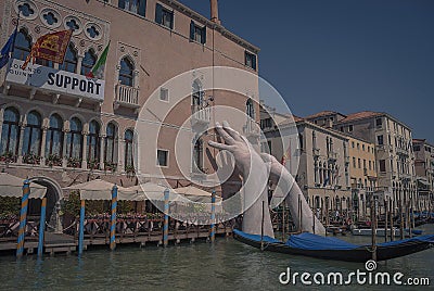 The giant hands of the `Support` art piece in the Grand Canal in Venice Editorial Stock Photo