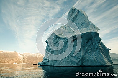 Giant Iceberg with Inflatable Boat Scale - Greenland Stock Photo