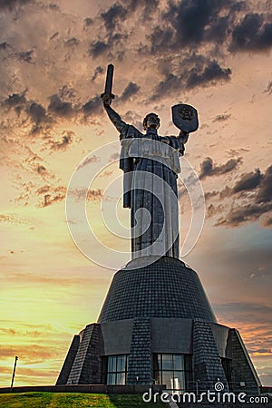 Giant Kiev`s Motherland Monument, huge figure of a woman holding a sword and a shield. Dramatic late afternoon, golden sunset Editorial Stock Photo